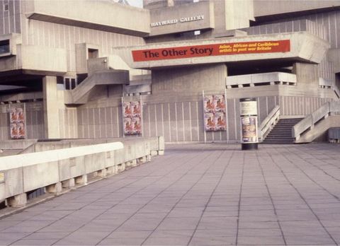 Architecture. Across a stone plaza, a concrete building has ledges and staircases spanning the stepped and faceted design.